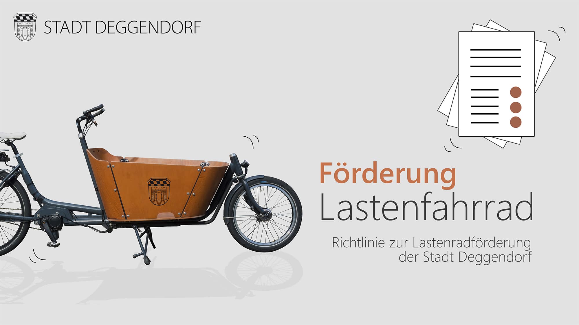 Lastenfahrrad mit Förderhinweisen der Stadt Deggendorf und stilisierten Antragsunterlagen