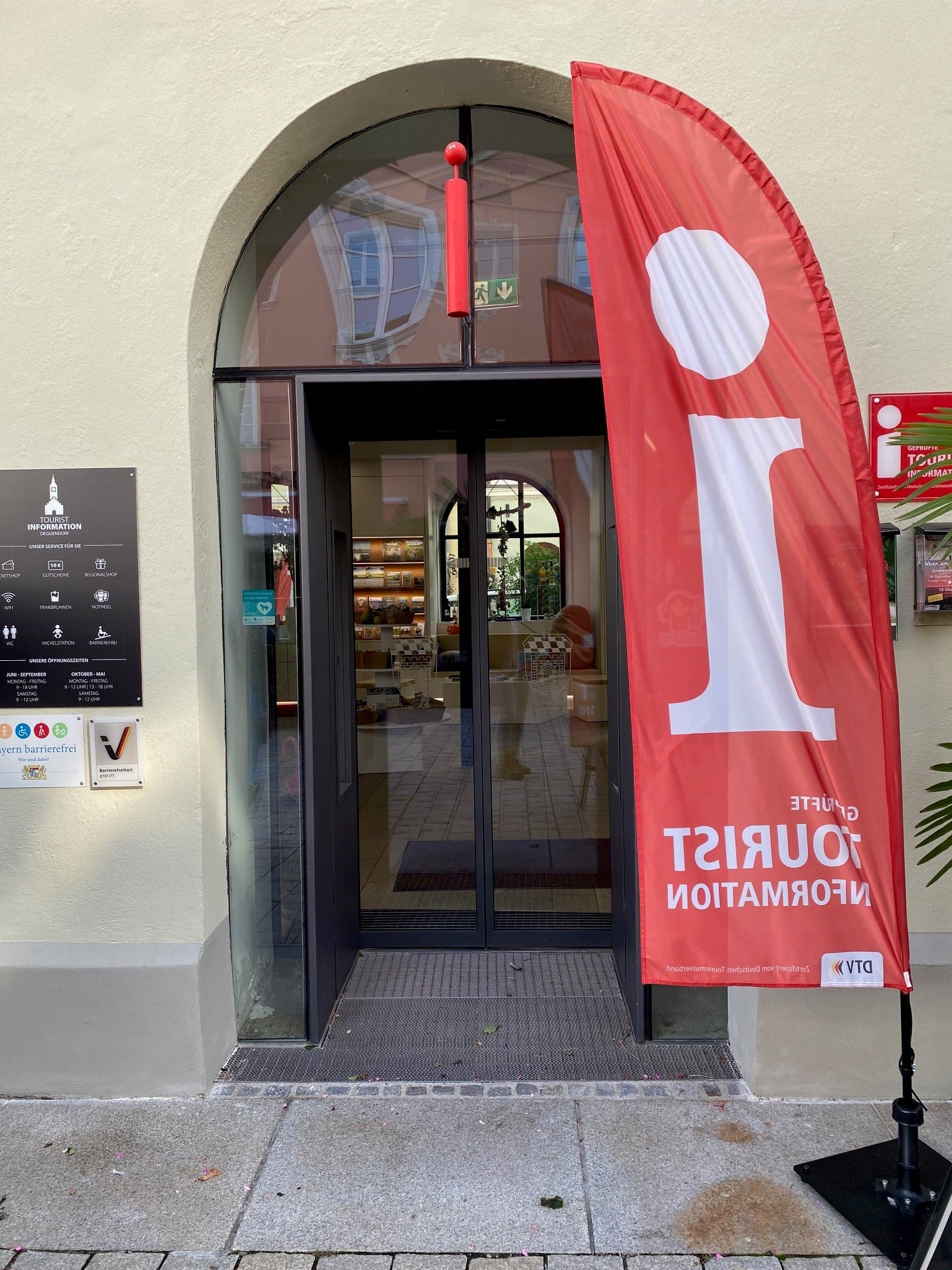 Winteröffnungszeiten der Tourist-Information Deggendorf 2026 Eingang der Tourist-Information mit roter Fahne vor der Tür